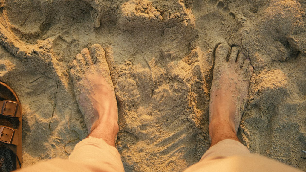 Breaking the Cycle: What Causes Toe Nail Fungus Relapse? Feet Buried In Beach Sand