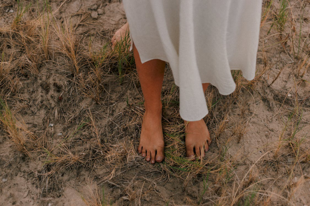 Walking with Toenail Fungus: Long-Term Impact on Foot Health Bare Feet On Dry Grass